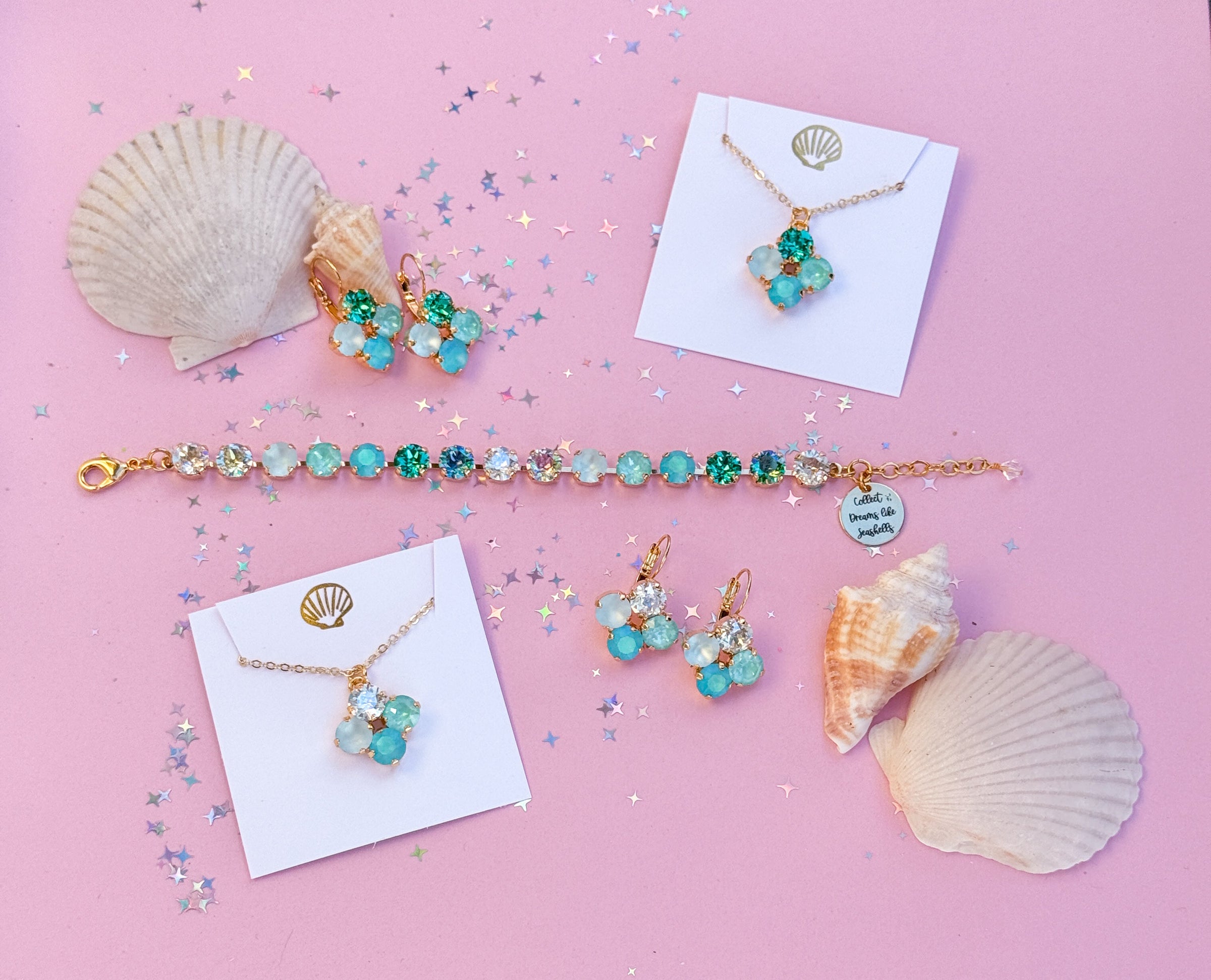 group of jewelry pieces with seashells and pink background