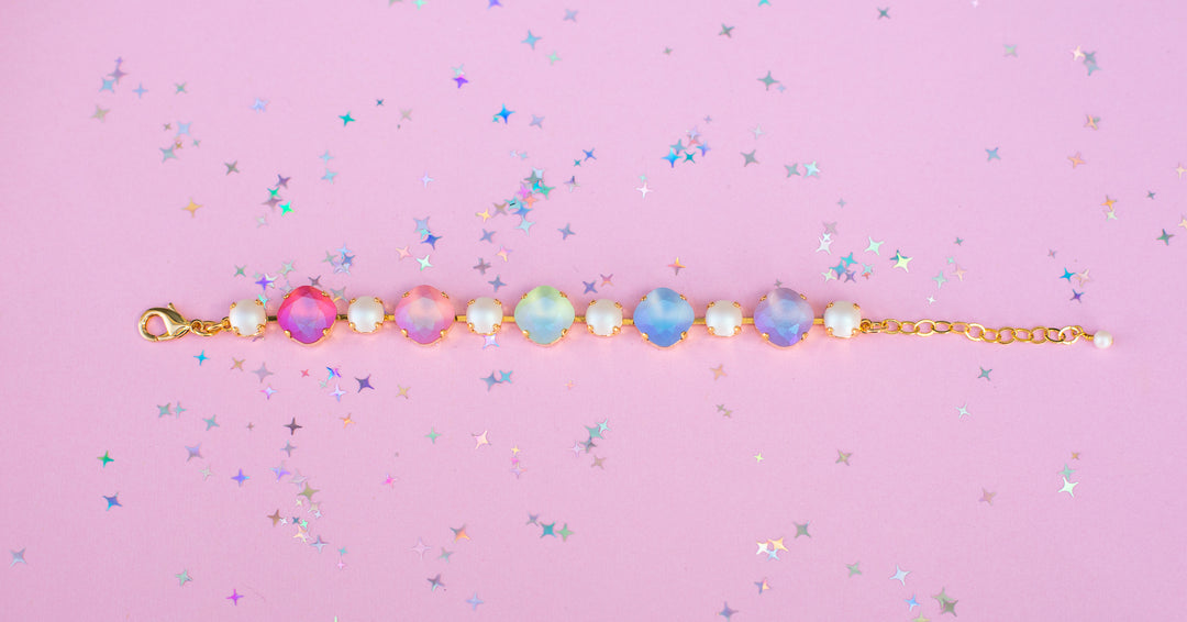 Bracelet with colorful gemstones on a pink background