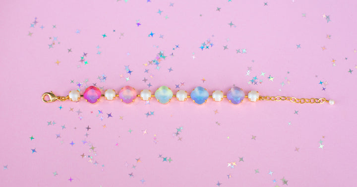 Bracelet with colorful gemstones on a pink background