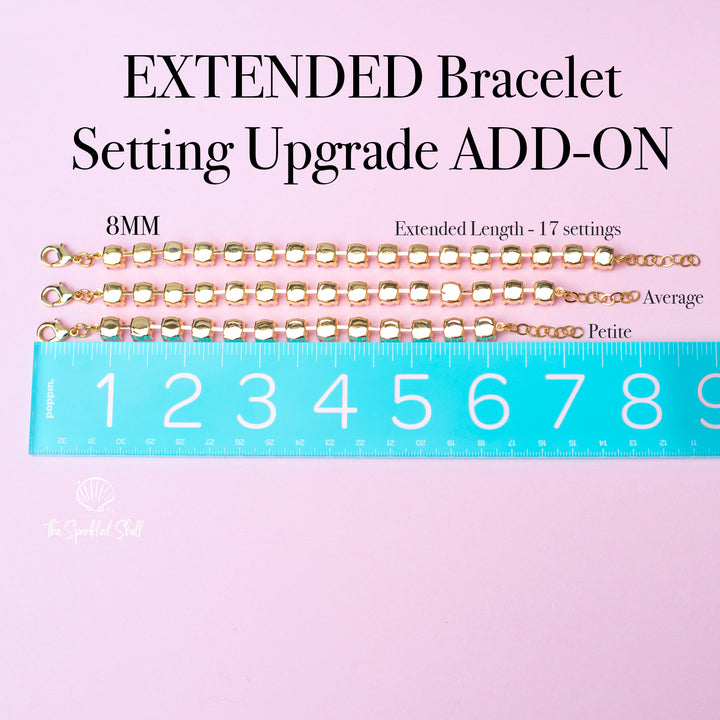 Gold bracelet extensions with a ruler on a pink background