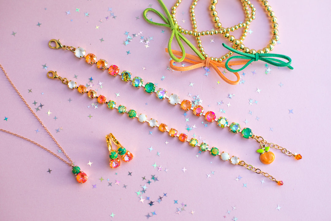 Colorful beaded necklaces with green bows on a pink background