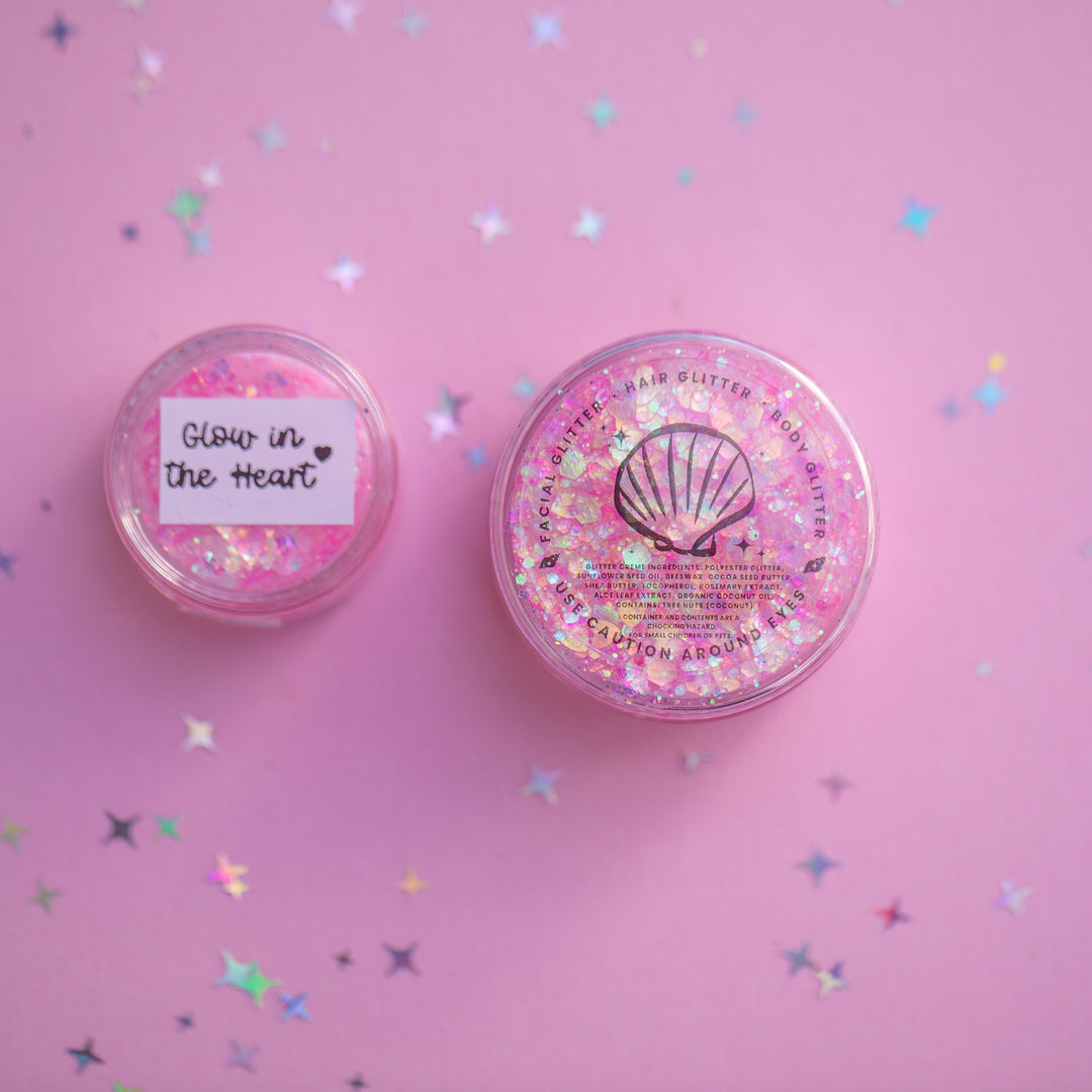 Two glittery containers on a pink background with confetti