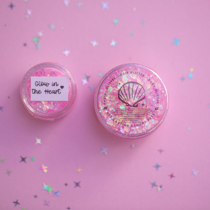 Two glittery containers on a pink background with confetti