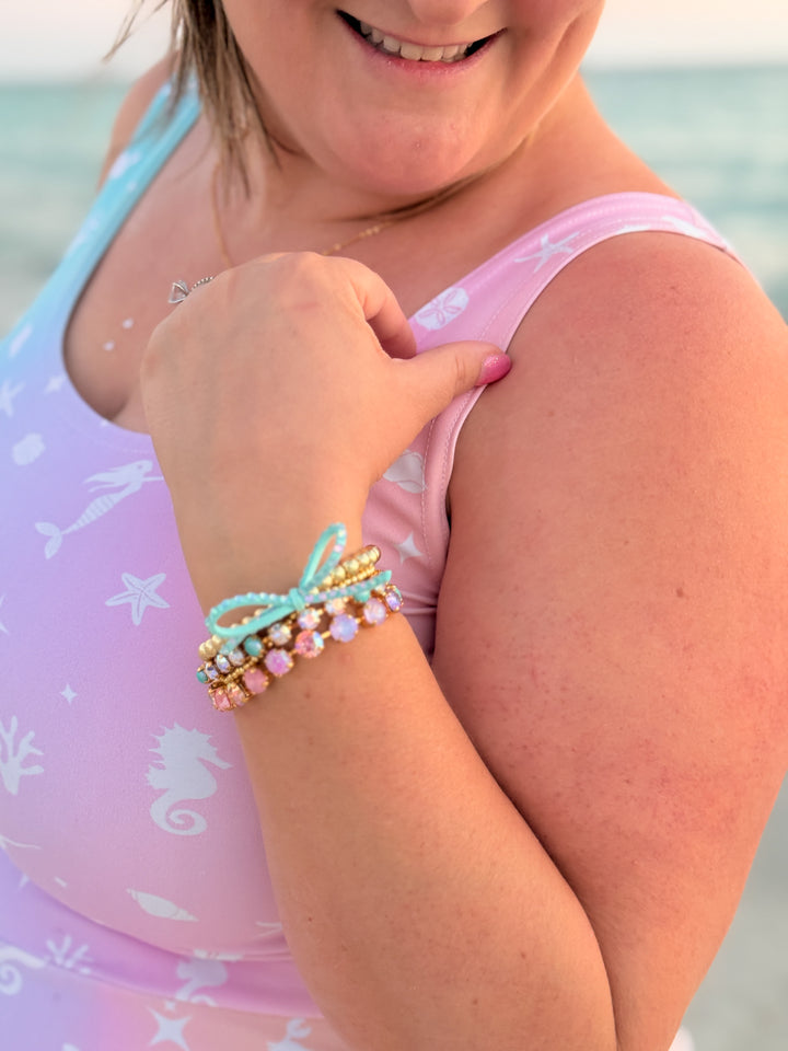 Person wearing colorful bracelets on a beach