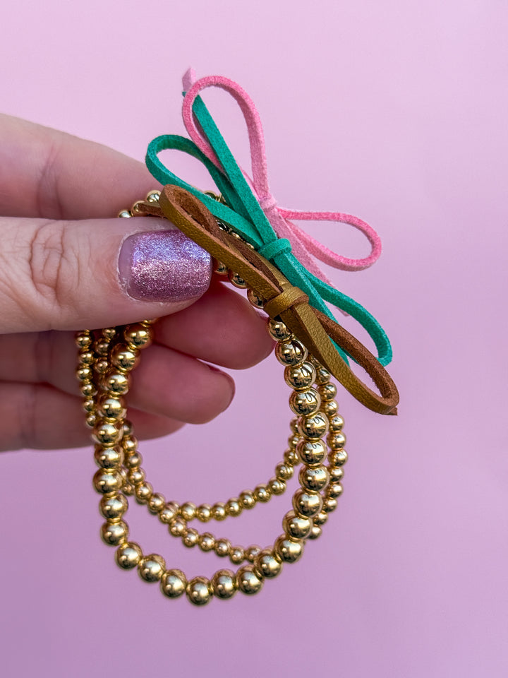 Suede Bow Stretch Beaded Bracelet - Choose setting Color (Pink Goes Good with Green)