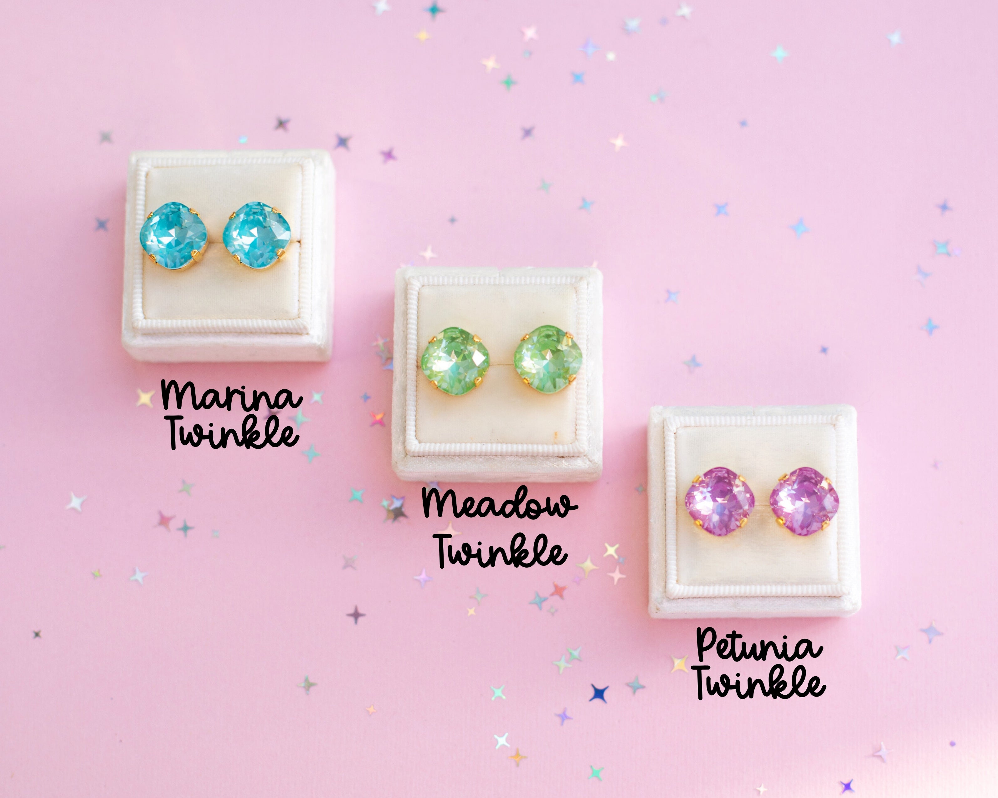Three pairs of twinkle earrings in different colors on a pink background with 'Twinkle' text.