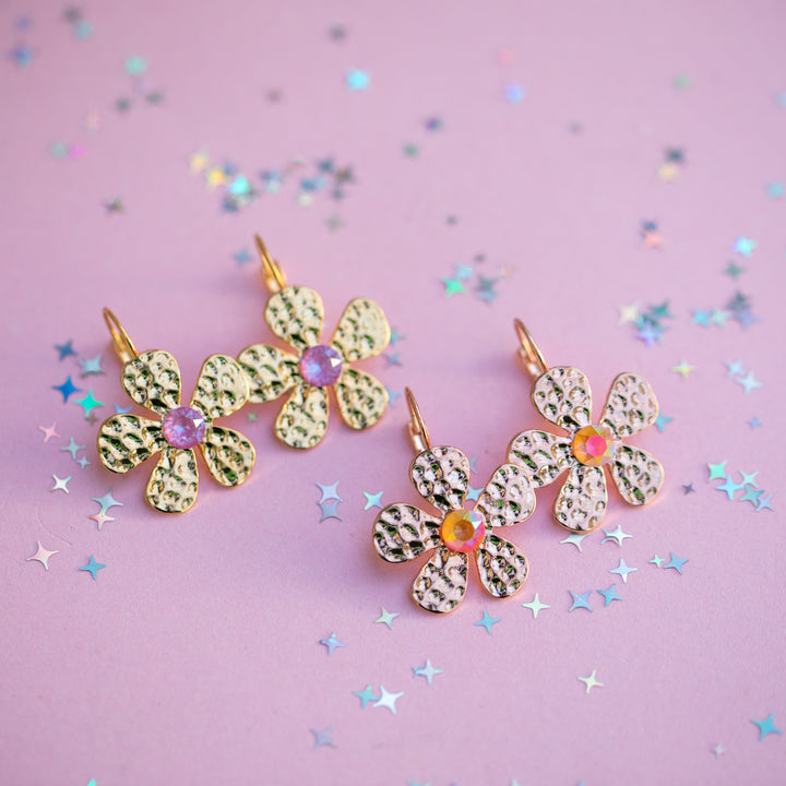 flower earrings on a pink background