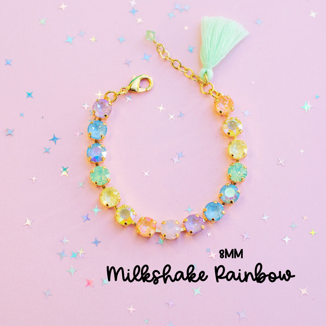 Bracelet with colorful beads and a tassel on a pink background