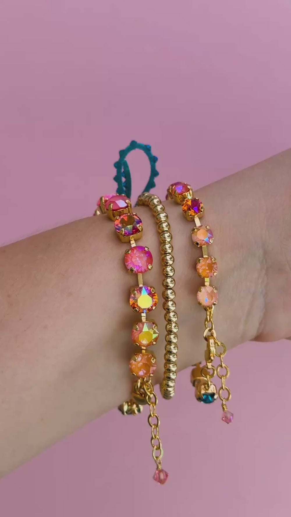video of 3 bracelets on a wrist in colorful crystals.